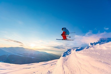 good skiing in the snowy mountains, carpathians, ukraine. beautiful winter sunset, incredible ski jump.