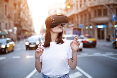 handsome petite female back end developer explores exciting and thrilling world of augmented virtual reality in the middle of a busy multi cultural city