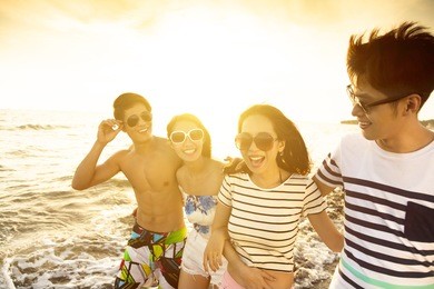happy young group walking on the beach enjoy summer vacation