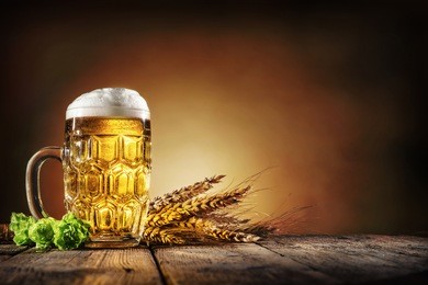 oktoberfest beer with wheat  and hops on wooden table