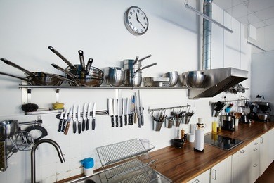various types of metallic kitchenware and workplace of chef