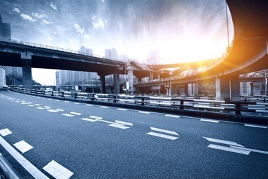 highway overpass motion blur with city background .