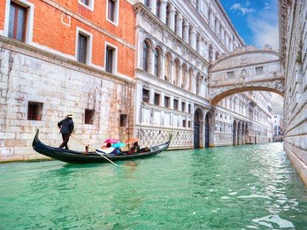 traditional gondola and the famous bridge of sighs in venice, italy