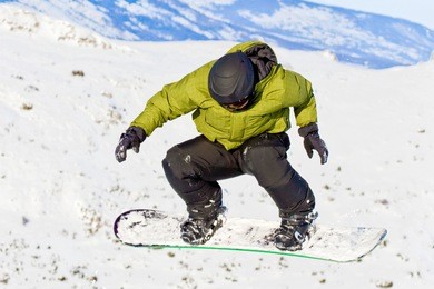 boy snowboarding caught in a jump