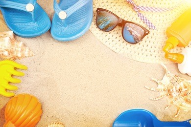 beach accessories on sand background. family holiday