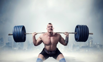 muscular male weightlifter exercise with barbell