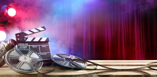 film movie background - clapperboard and film reels in theater
