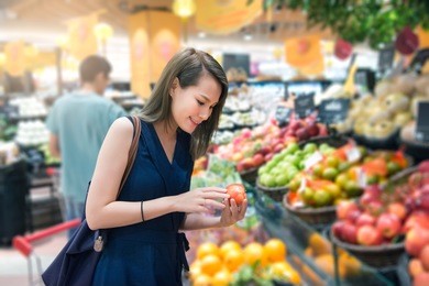 beautiful women shopping vegetables and fruits in supermarket