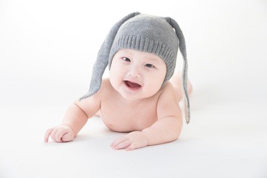 smiling cute asian baby isolated on white,baby wearing wool rabbit hat