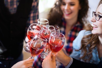 wine tasting event by happy people concept