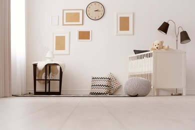 interior of light cozy baby room with crib and bedding