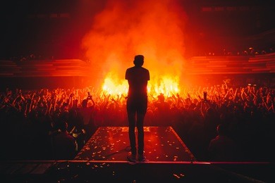 band on stage.  music show. bright scene lighting in club. fans burn red flares at rock concert. view from the stage to the vocalist. russian punk rock band.