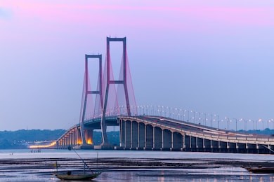 the suramadu bridge at twilight with colorful lighting in surabaya,indonesia.is the longest bridge in indonesia.