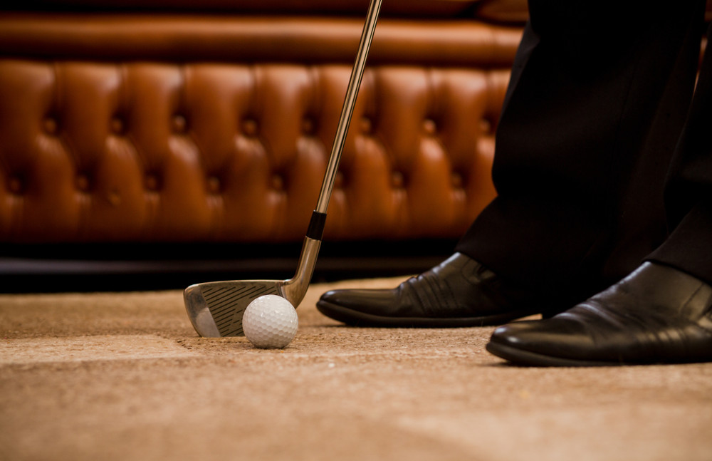 man playing golf at office alone. sport for recovering your nerves after hard working day or week. golf at office concept.