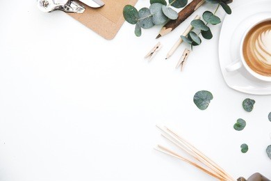 blogger or freelancer workspace with clipboard and coffee on white background. flat lay, top view.