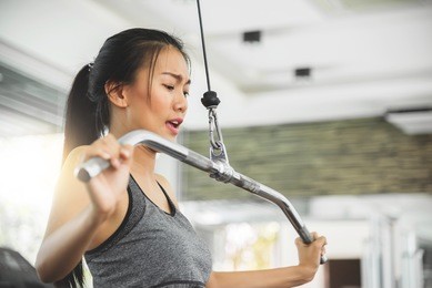 asian woman in sportswear exercising with exercise machine at the gym.