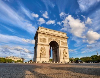 arc de triumph in paris, france, on a bright afternoon with feather clouds behing, panoramic image.
