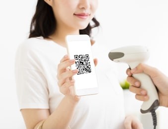 young woman pay by smart phone with qr code