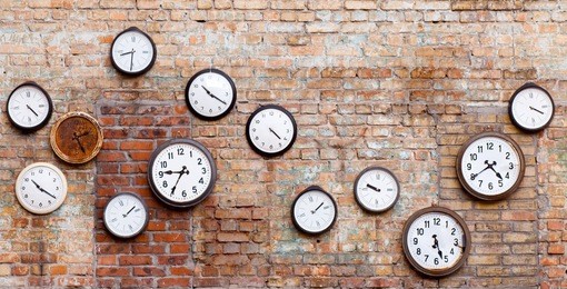 vintage clocks on old brick wall.