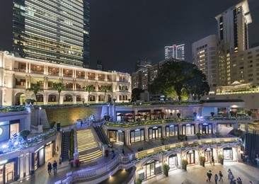 old and modern buildings in tsim sha tsui district, hong kong city at night