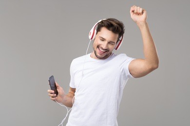 happy young man with headphones. listening music