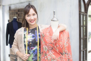 beautiful young asian designer in her dress fashion at showroom, 20s age