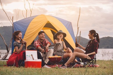 dinner party, drink beer camping barbecue and roast pork ,group of attractive young people toasting with a delicious beer ,friends drinking outdoors before festival,relaxation fun concept.