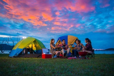 camping of happy asian young travellers at lake, asian man and women group, relaxing, sing a song and cooking, at sunset.