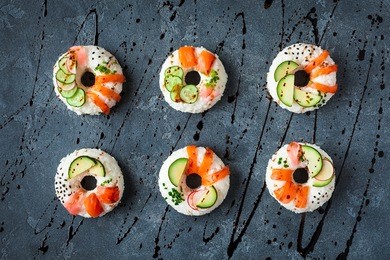 sushi donuts set on black background. sushi trend. creative food. flat lay, top view