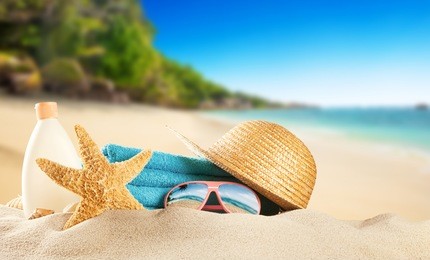 tropical beach with sunbathing accessories, summer holiday background. travel and beach vacation, free space for text.