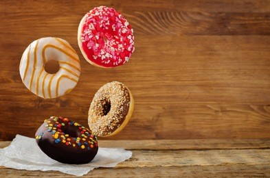 flying donuts on a wood background. toning. selective focus