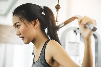 asian woman in sportswear exercising with exercise machine at the gym.