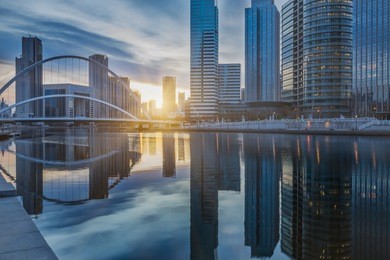 downtown city skyline along the river at twilight in tianjin,china.