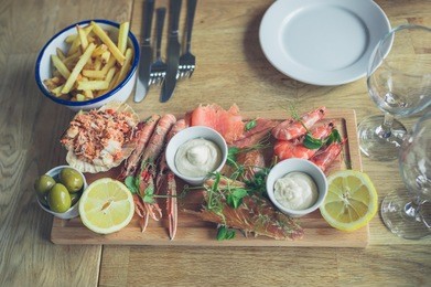 a seafood platter in a restaurant with prawns, langoustines, salmon and crab