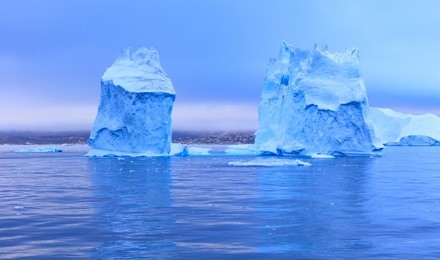 icebergs in front of the fishing town ilulissat in greenland