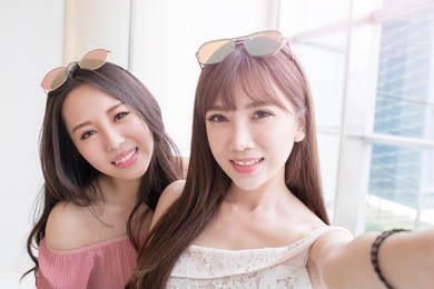 women selfie and smile happily in the shopping mall