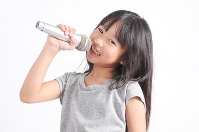 pretty little girl with the microphone in her hand