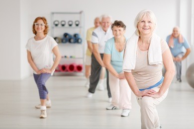 elderly people exercising in a group in fitness club