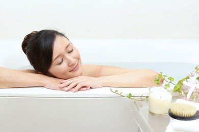 young beautiful woman taking relaxing bath