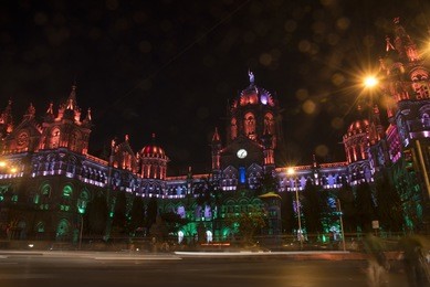 chhattrapati chivaji terminus illuminated with multicolored lights in the evening for india independence day with light trail of traffic circa august 2015
