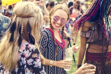 group of friends drinking beers enjoying music festival together