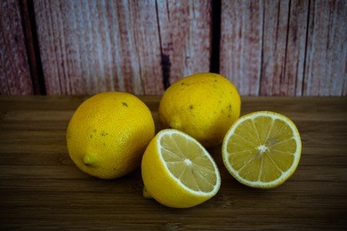 fresh yellow lemon on wooden background.