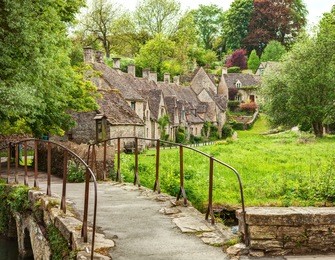 old footbridge and  traditional cotswold cottages,   bibury,  england, uk.