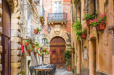 cafe tables and chairs outside in old cozy street in the positano town, campania, italy