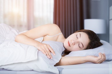 woman sleeping on bed in the bedroom with soft light