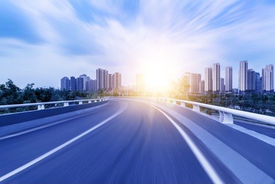 highway overpass motion blur with city background .