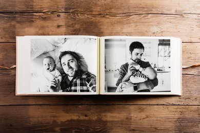 photo album with pictures of father and baby son. fathers day.