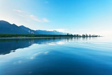 lake baikal. a quiet summer evening. view from the water to the west coast and the pebble shoal