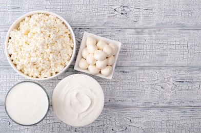 dairy products on wooden table. milk, sour cream, cheese, curd and yogurt. farmers products. healthy eating and diet concept. top view