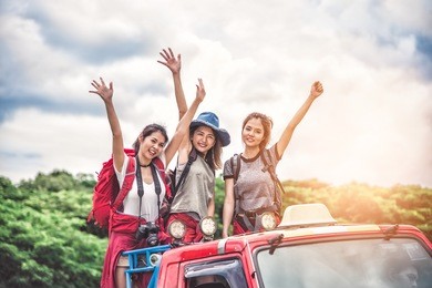 group of women friends backpacker enjoy road trip traveling and camping in the forest in weekend summer - travel and recreation concept